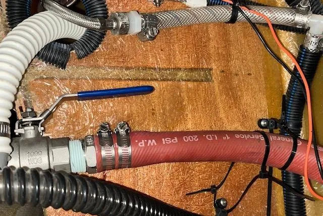 Mystic Yacht Photos Pics Plumbing system in 2014 Ranger Tugs R-31 boat, featuring hoses and valves.