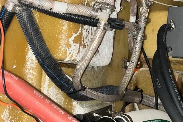 Mystic Yacht Photos Pics Engine compartment of a 2014 Ranger Tugs R-31 with various hoses and wiring.