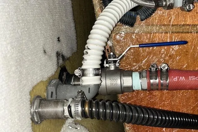 Mystic Yacht Photos Pics Plumbing system in a 2014 Ranger Tugs R-31 boat, featuring hoses and valves.