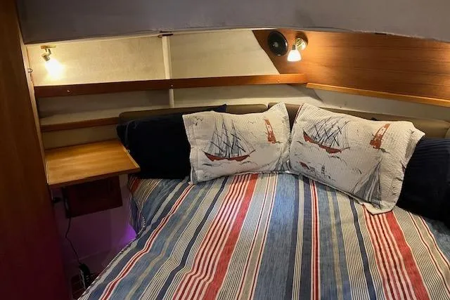 Mystic Yacht Photos Pics Cozy cabin interior of 2014 Ranger Tugs R-31 with nautical-themed bedding.