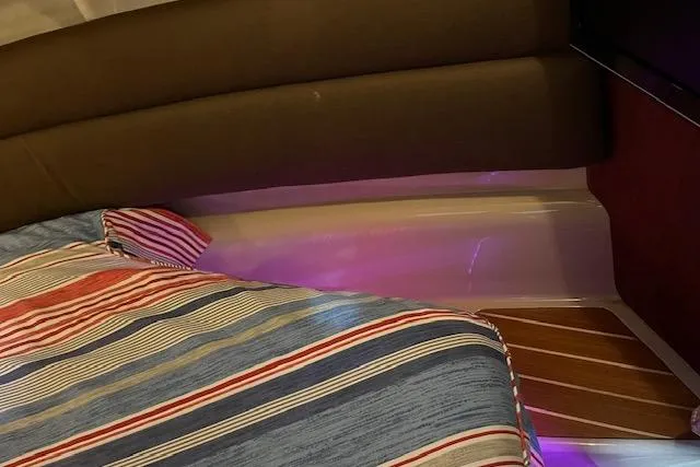 Mystic Yacht Photos Pics Interior of 2014 Ranger Tugs R-31 with striped bedding and ambient lighting.