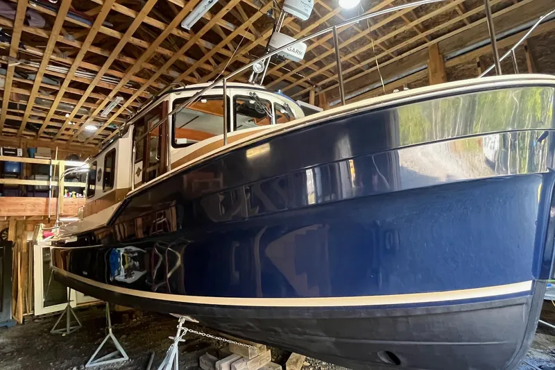 Mystic Yacht Photos Pics 2014 Ranger Tugs R-31 boat in storage, showcasing sleek blue hull and classic design.