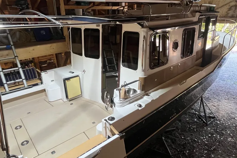 Mystic Yacht Photos Pics 2014 Ranger Tugs R-31 boat in storage, showcasing deck and cabin details.