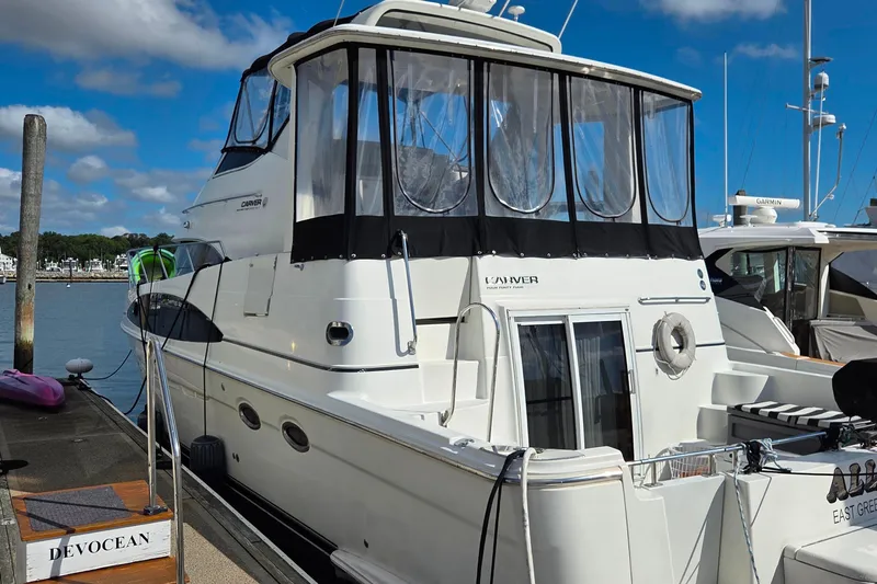 All In Yacht Photos Pics 2004 Carver 444 Cockpit Motor Yacht docked at marina under blue sky.