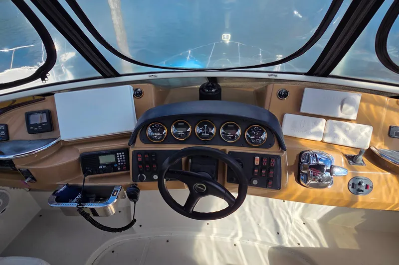 All In Yacht Photos Pics Cockpit view of 2004 Carver 444 Cockpit Motor Yacht with steering wheel and control panel.