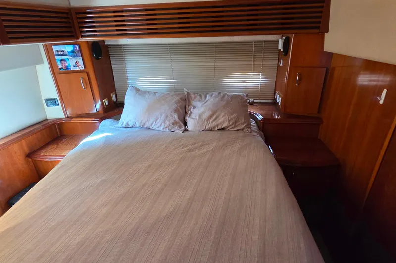 All In Yacht Photos Pics Luxurious bedroom interior of 2004 Carver 444 Cockpit Motor Yacht with wooden cabinetry.