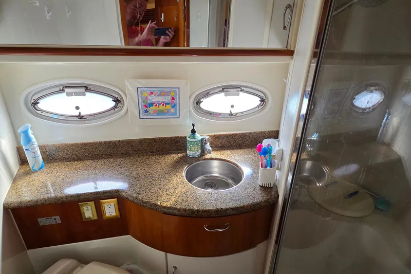 All In Yacht Photos Pics 2004 Carver 444 Cockpit Motor Yacht bathroom with granite countertop and oval windows.