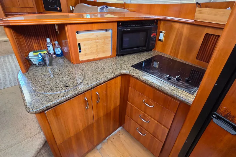 All In Yacht Photos Pics 2004 Carver 444 Cockpit Motor Yacht kitchen with granite countertops and modern appliances.