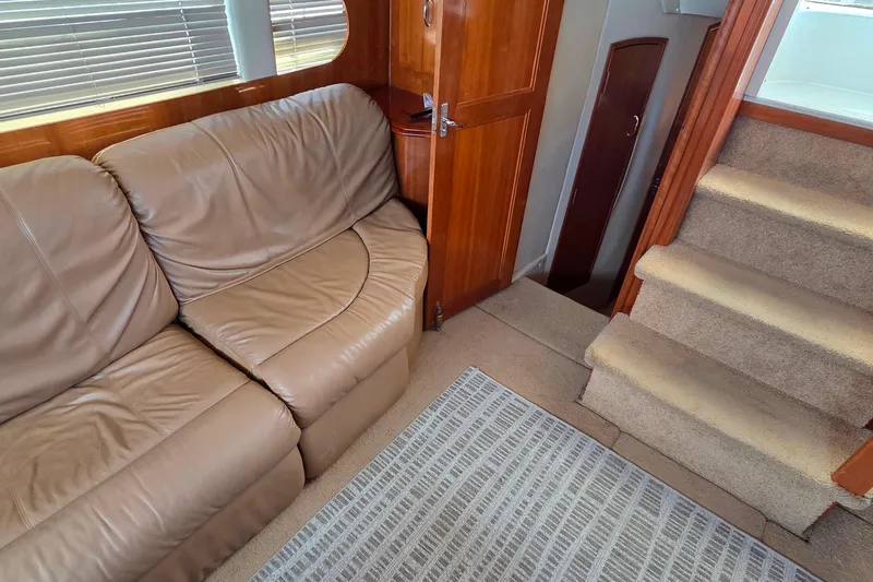 All In Yacht Photos Pics Interior of 2004 Carver 444 Cockpit Motor Yacht with leather sofa and carpeted stairs.