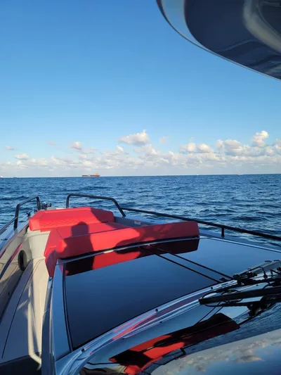  Yacht Photos Pics 2022 Axopar Brabus Shadow 900 ST cruising on open sea under clear blue sky.