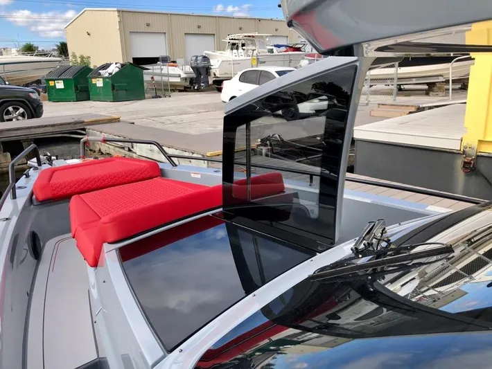  Yacht Photos Pics 2022 Axopar Brabus Shadow 900 ST with red seating, docked at a marina.