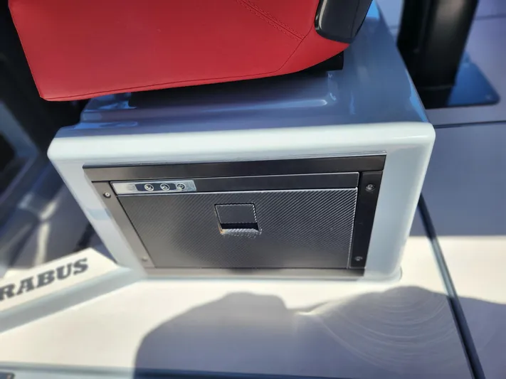  Yacht Photos Pics 2022 Axopar Brabus Shadow 900 ST interior detail with red seat and storage compartment.
