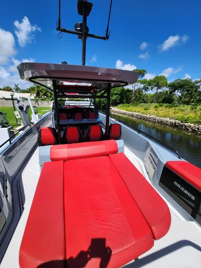  Yacht Photos Pics 2022 Axopar Brabus Shadow 900 ST with red seating, docked by a scenic canal.