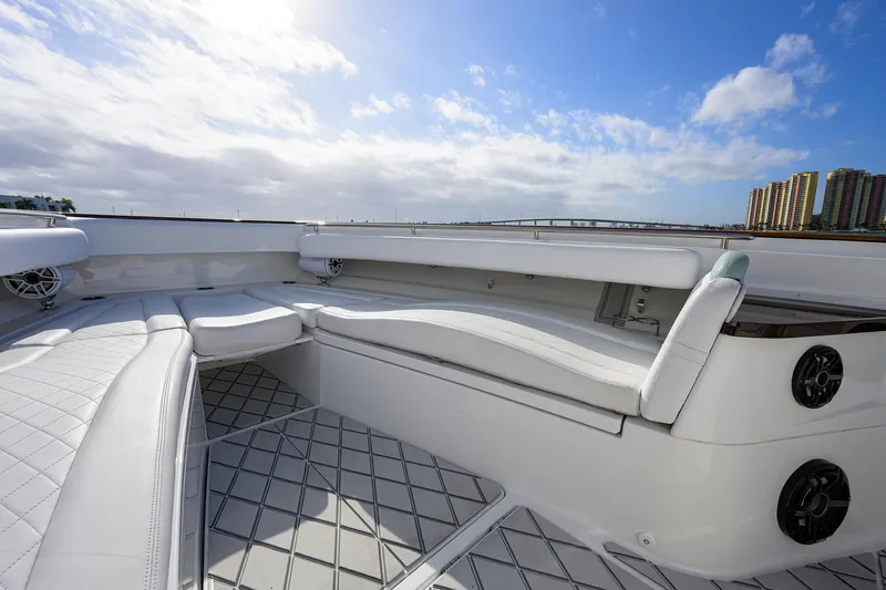  Yacht Photos Pics Luxurious seating on 2021 HCB 53 Sueños boat under a bright blue sky.