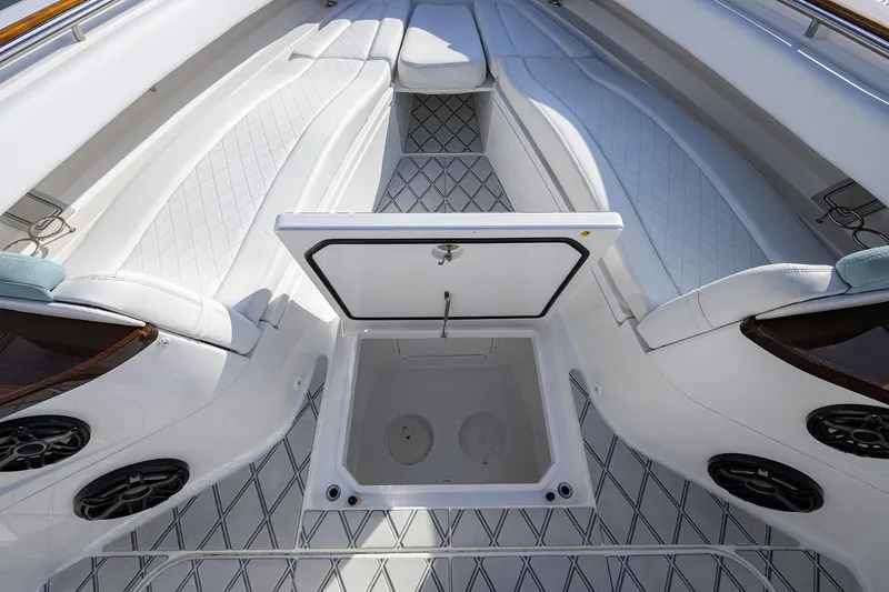  Yacht Photos Pics 2021 HCB 53 Sueños boat interior with open storage compartment and cushioned seating.