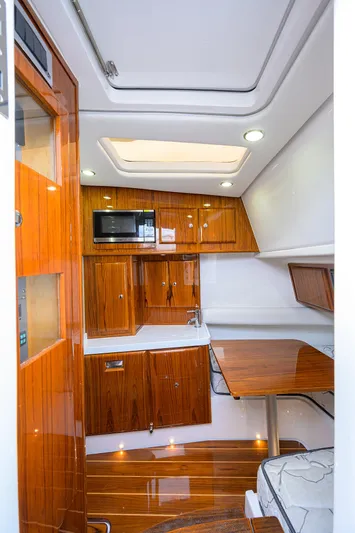  Yacht Photos Pics Luxurious 2021 HCB 53 Sueños yacht interior with polished wood and modern amenities.