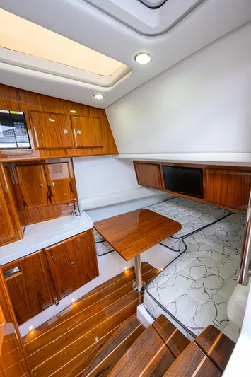  Yacht Photos Pics Luxurious interior of 2021 HCB 53 Sueños boat with wood finishes and seating area.