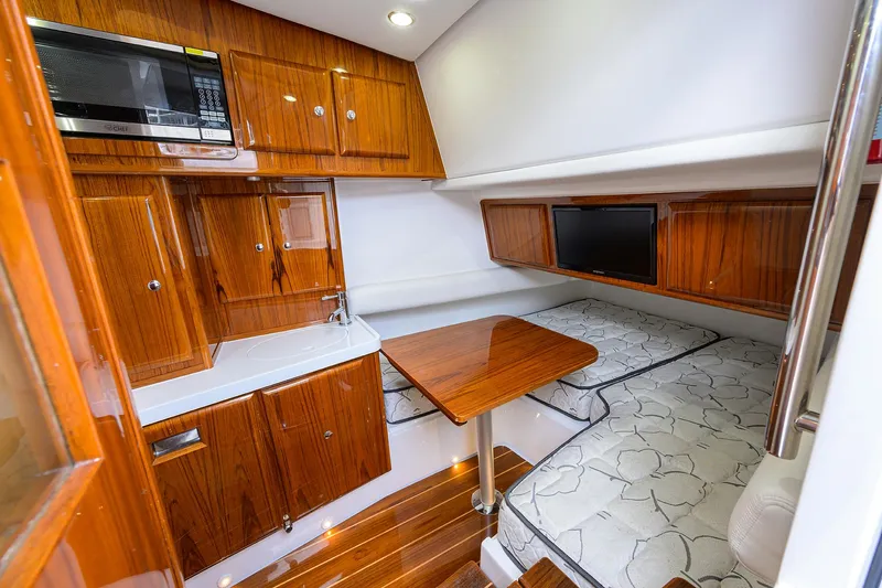  Yacht Photos Pics Luxurious cabin interior of 2021 HCB 53 Sueños with wood finish and modern amenities.