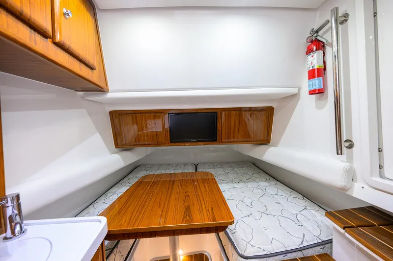  Yacht Photos Pics 2021 HCB 53 Sueños cabin interior with wood accents and a small TV.
