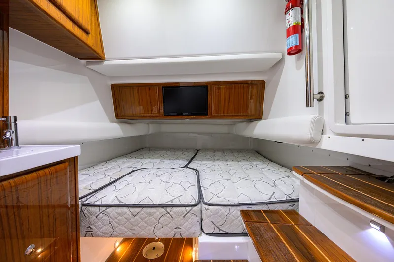  Yacht Photos Pics Luxurious cabin interior of 2021 HCB 53 Sueños with wood accents and bedding.