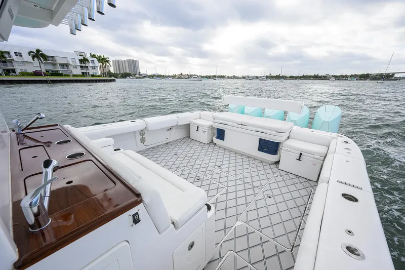  Yacht Photos Pics Spacious deck of 2021 HCB 53 Sueños boat on water, featuring luxurious seating.