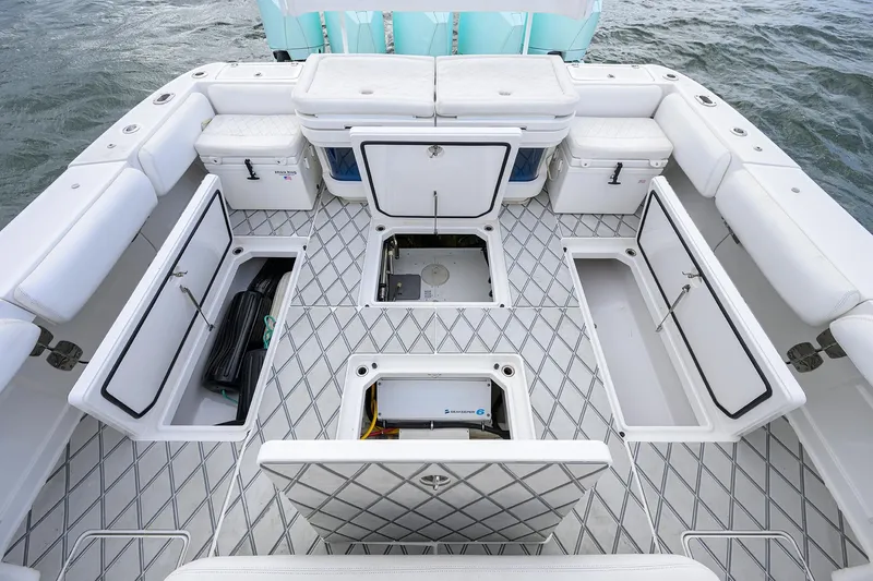  Yacht Photos Pics 2021 HCB 53 Sueños boat interior with open storage compartments and cushioned seating.