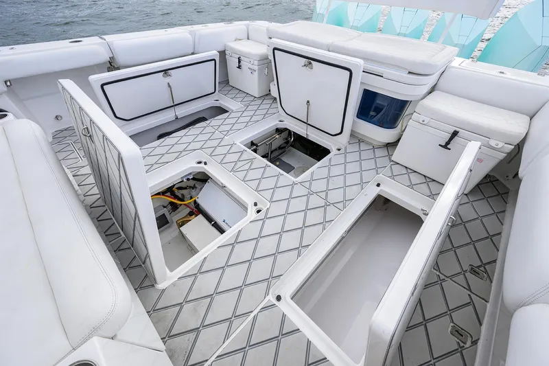  Yacht Photos Pics 2021 HCB 53 Sueños boat interior with open storage compartments and cushioned seating.