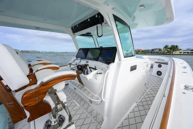  Yacht Photos Pics 2021 HCB 53 Sueños boat interior with helm, luxurious seating, and ocean view.