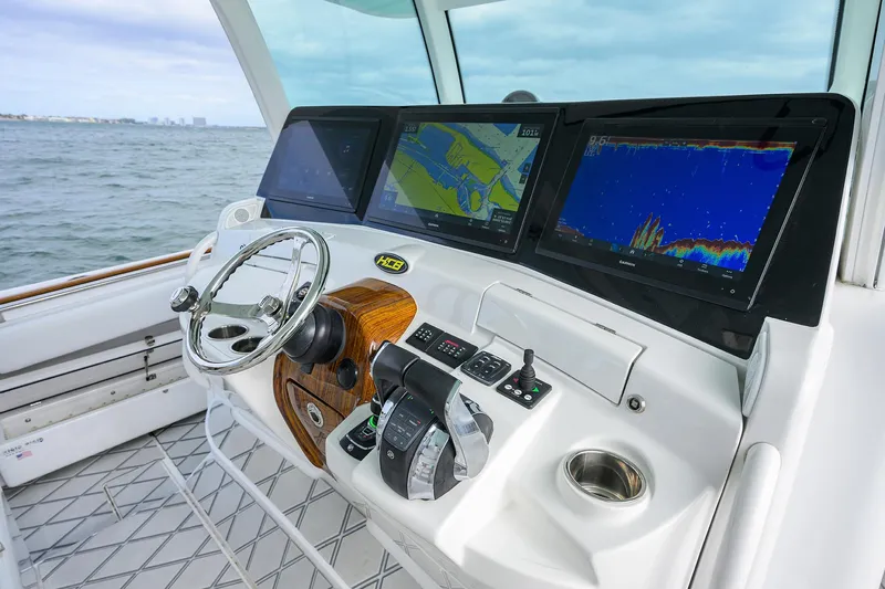  Yacht Photos Pics HCB 53 Sueños 2021 boat dashboard with navigation screens and steering wheel.