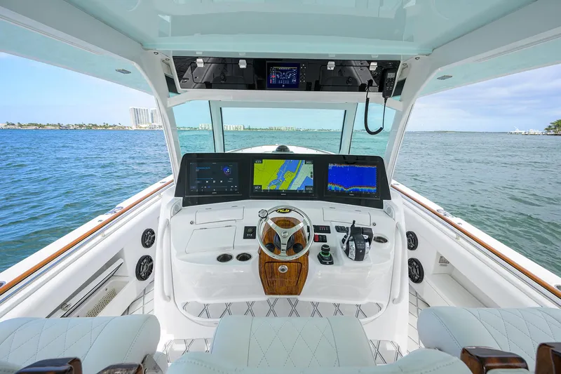  Yacht Photos Pics 2021 HCB 53 Sueños boat helm with advanced navigation displays on open water.