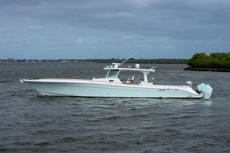  Yacht Photos Pics 2021 HCB 53 Sueños boat cruising on a calm, scenic waterway.