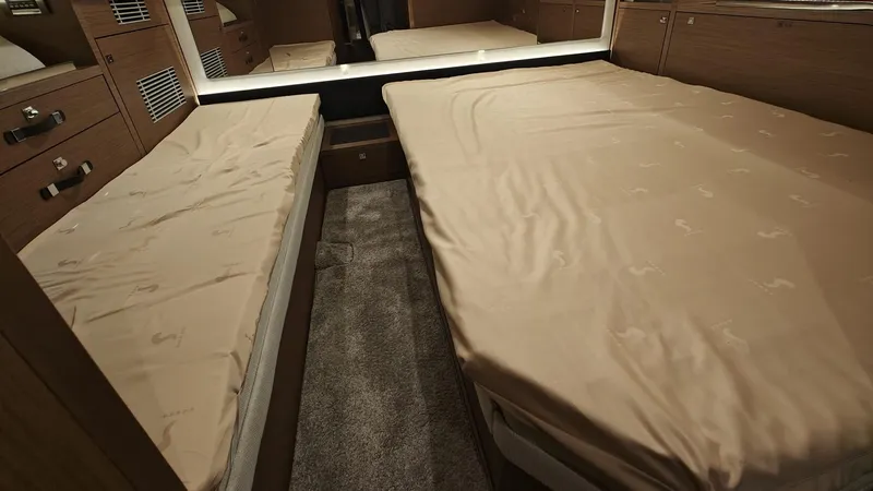  Yacht Photos Pics Interior cabin of 2021 Jeanneau CAP CAMARAT 12.5WA with twin beds and wooden finish.