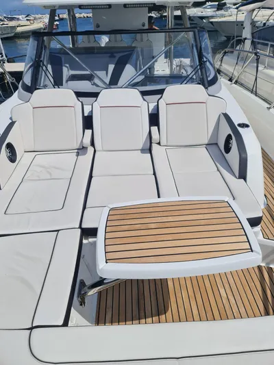  Yacht Photos Pics 2021 Jeanneau CAP CAMARAT 12.5WA boat with sleek seating and wooden deck.