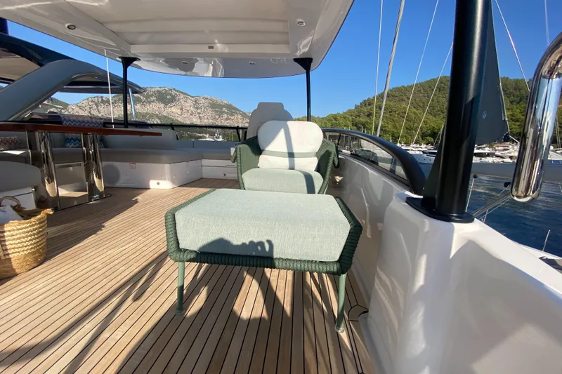  Yacht Photos Pics Luxurious deck of 2025 Azimut Magellano 66 yacht with elegant seating and scenic views.