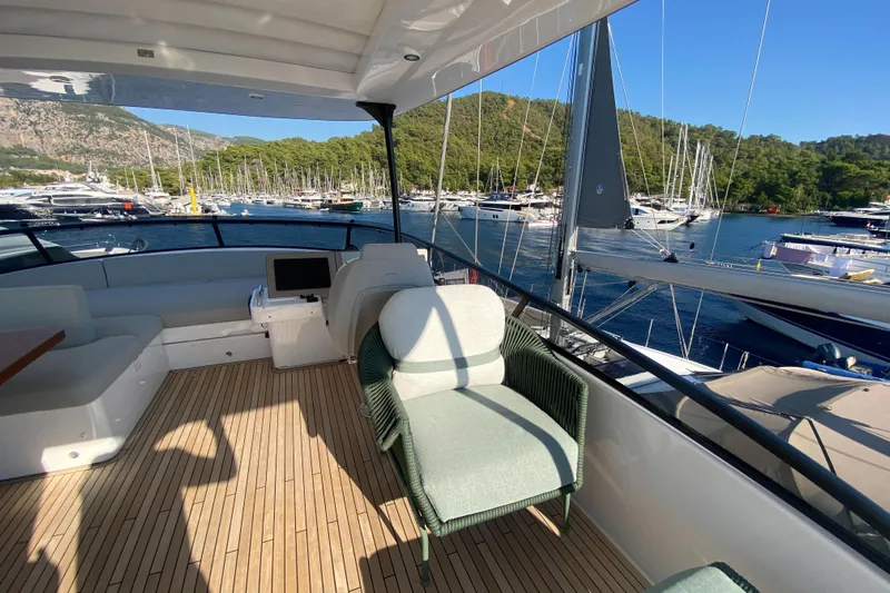  Yacht Photos Pics Azimut Magellano 66 yacht deck with seating, overlooking marina and scenic landscape, 2025 model.