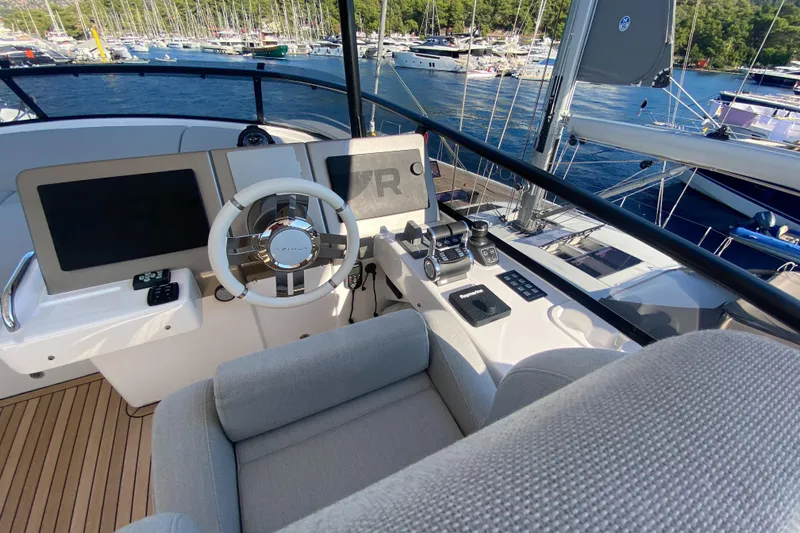  Yacht Photos Pics Helm of 2025 Azimut Magellano 66 yacht with modern controls and navigation screens.