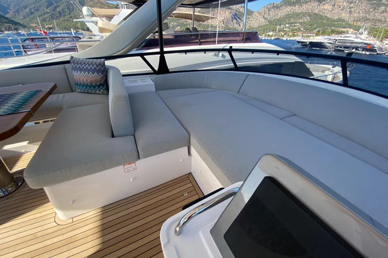  Yacht Photos Pics Luxurious seating area on 2025 Azimut Magellano 66 yacht, with scenic marina backdrop.