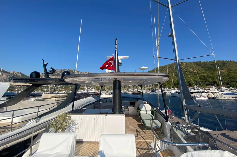  Yacht Photos Pics 2025 Azimut Magellano 66 yacht docked in a marina, featuring spacious deck and modern design.