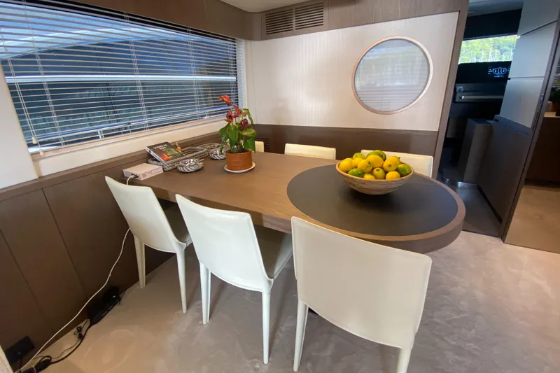  Yacht Photos Pics Dining area in 2025 Azimut Magellano 66 yacht with modern decor and fruit bowl centerpiece.