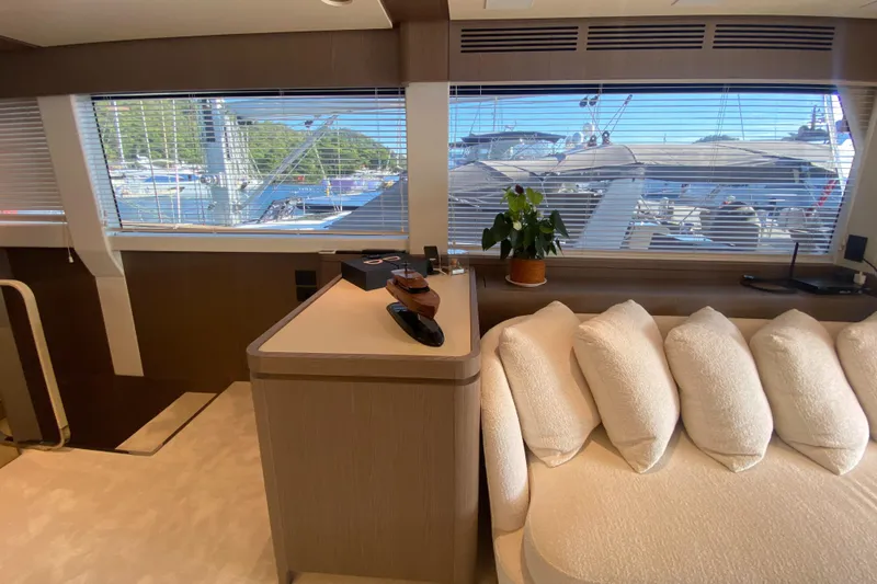 Yacht Photos Pics Luxurious interior of 2025 Azimut Magellano 66 yacht with plush seating and scenic window view.