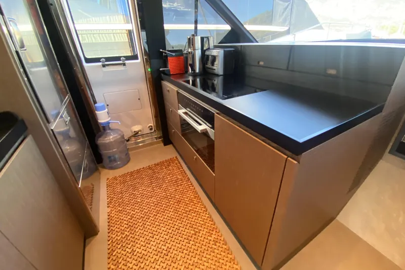  Yacht Photos Pics Modern kitchen interior on 2025 Azimut Magellano 66 yacht with sleek countertops and appliances.