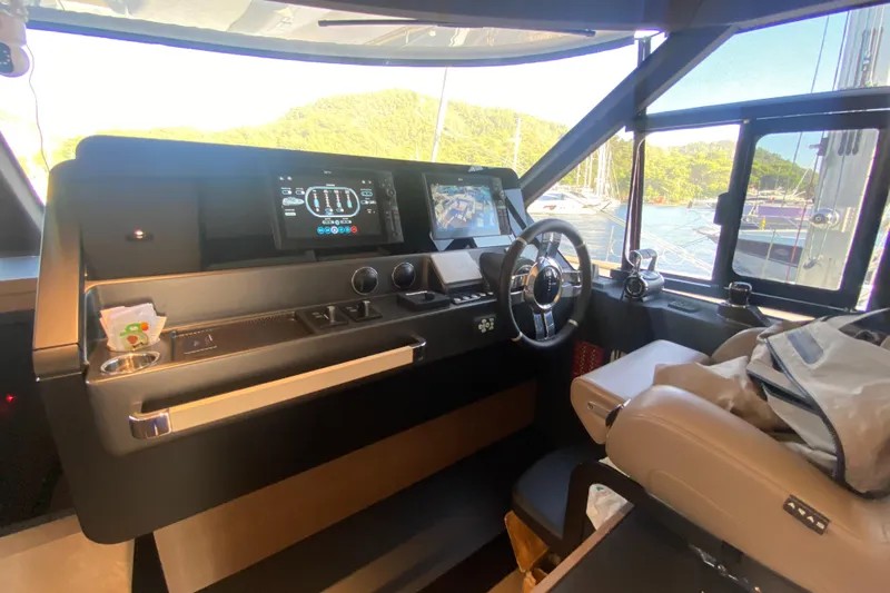  Yacht Photos Pics 2025 Azimut Magellano 66 yacht cockpit with modern navigation controls and panoramic windows.