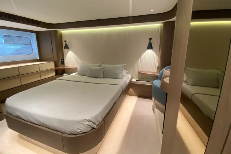  Yacht Photos Pics Luxurious bedroom interior of 2025 Azimut Magellano 66 yacht, featuring modern design and ambient lighting.
