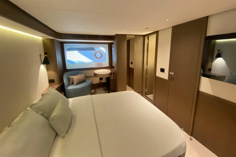  Yacht Photos Pics Luxurious bedroom interior of 2025 Azimut Magellano 66 yacht, featuring modern design and cozy furnishings.
