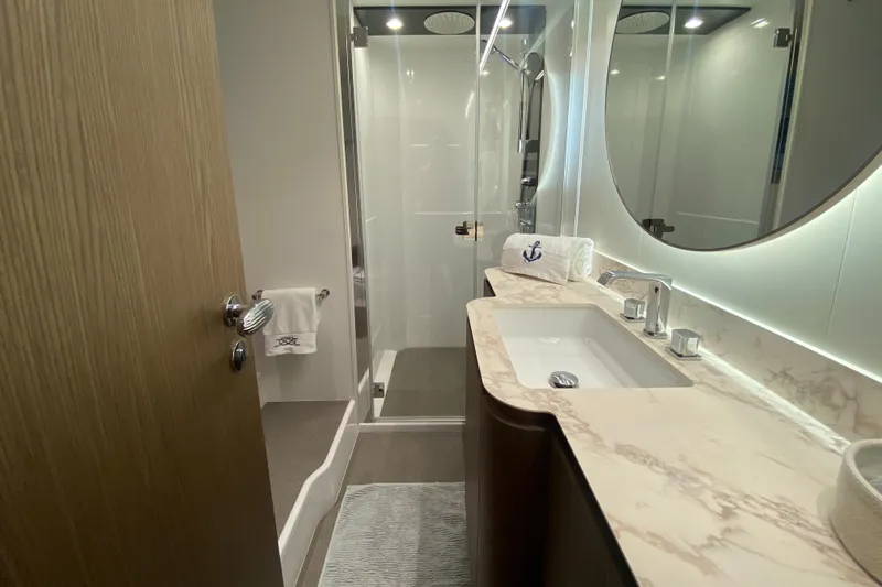  Yacht Photos Pics Luxurious bathroom in 2025 Azimut Magellano 66 yacht with modern fixtures and elegant design.