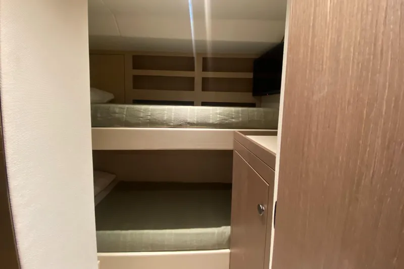  Yacht Photos Pics Bunk beds in the 2025 Azimut Magellano 66 yacht cabin, featuring modern wood finishes.