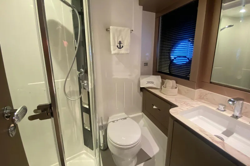  Yacht Photos Pics Luxurious bathroom in 2025 Azimut Magellano 66 yacht with shower and modern amenities.