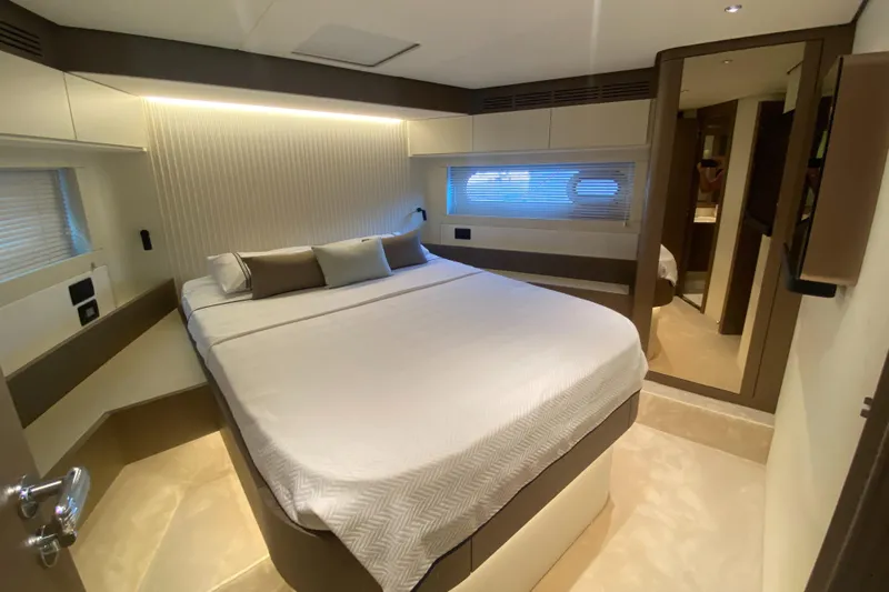  Yacht Photos Pics Luxurious bedroom interior of 2025 Azimut Magellano 66 yacht, featuring modern design and cozy ambiance.
