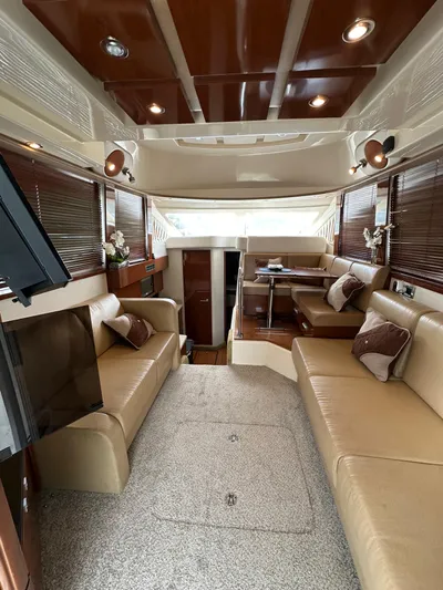  Yacht Photos Pics Luxurious interior of 2009 Sea Ray 36 Sedan Bridge with beige seating and wood accents.