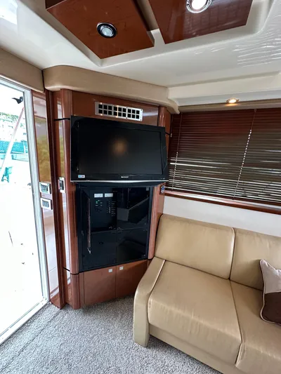  Yacht Photos Pics Interior of 2009 Sea Ray 36 Sedan Bridge with TV and beige sofa.